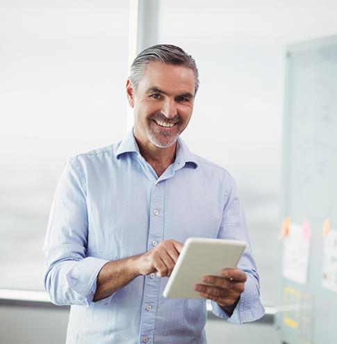 A happy Cardel Client uses a tablet.